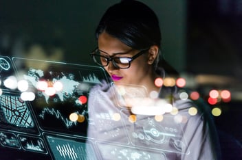 Woman engineer looking at various information in for cyber-physical systems